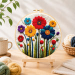 Finished bright and cheerful wildflowers needle felting displayed on a wooden easel