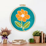 Finished bright orange flower artwork displayed on a wall