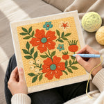 Creating handmade bright orange flowers punch needle artwork