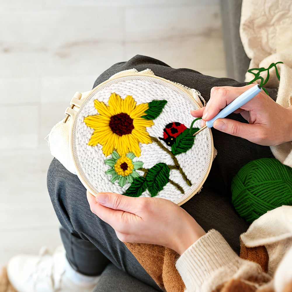 Creating handmade bright summer sunflowers and ladybug punch needle artwork