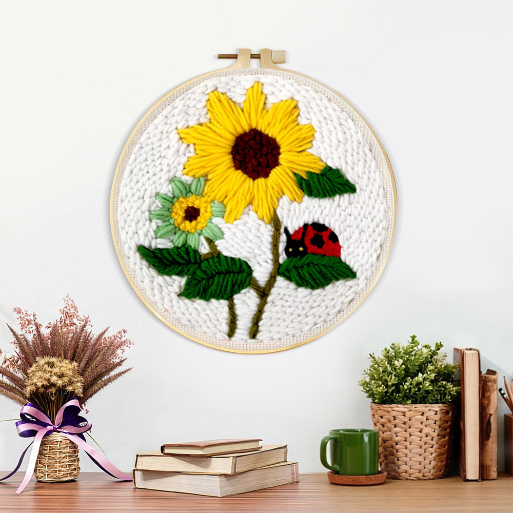 Finished bright summer sunflowers and ladybug artwork displayed on a wall