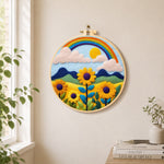 Bright sunflower and rainbow needle felt wall art displayed in a bright home interior