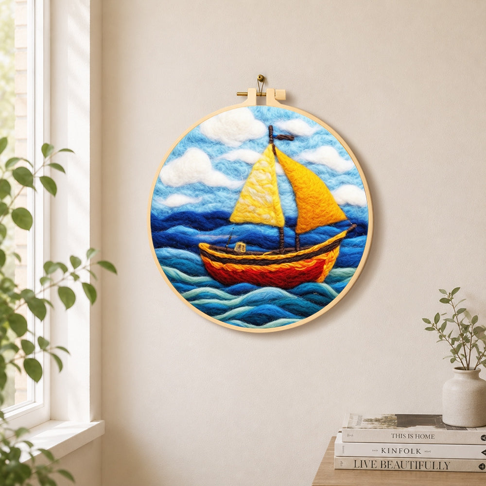 Bright yellow sailboat on blue waves needle felt wall art displayed in a bright home interior