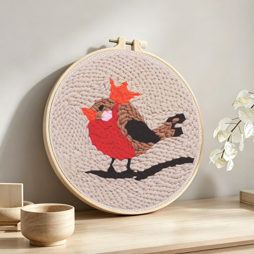 British robin punch needle artwork displayed on a table