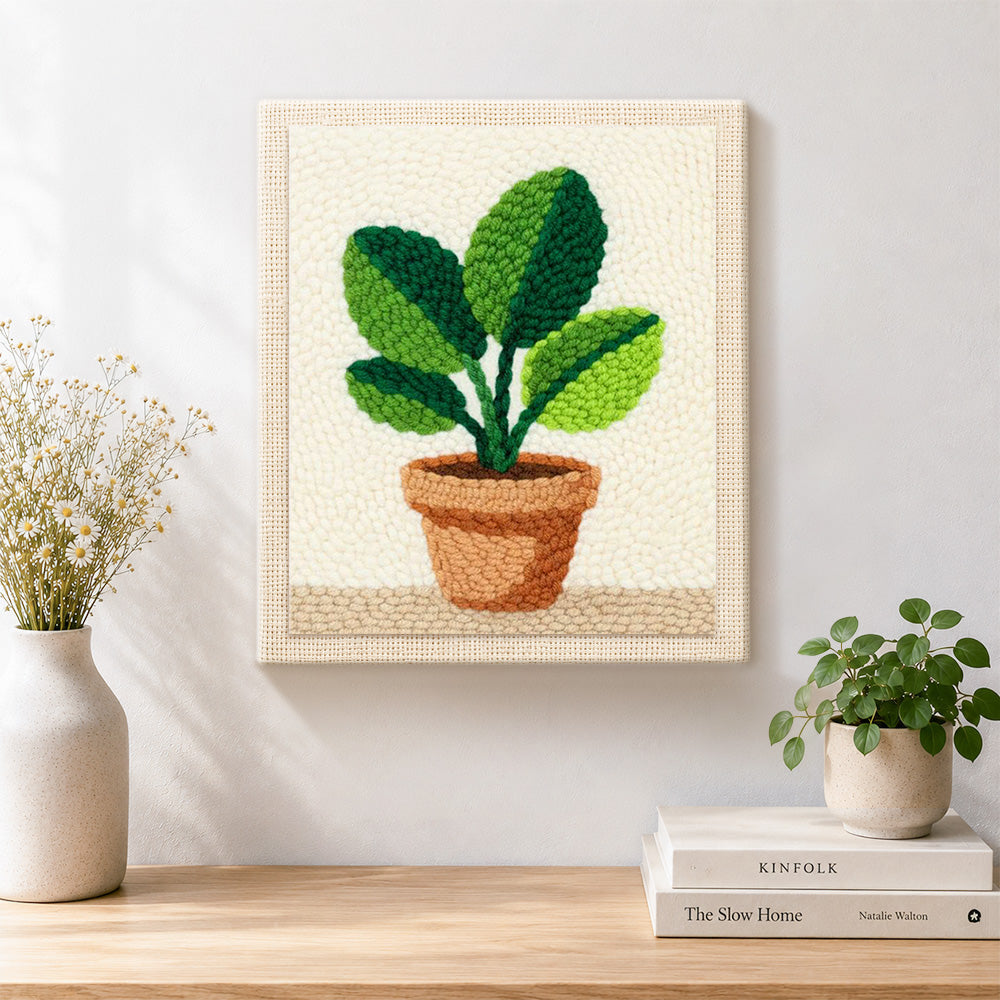 Finished broad leaf potted plant artwork displayed on a wall