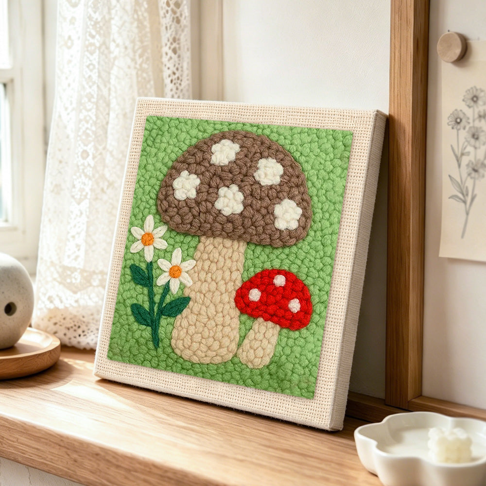 Brown and red mushrooms punch needle artwork displayed on a table