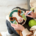 Creating handmade brown and white cow face punch needle artwork