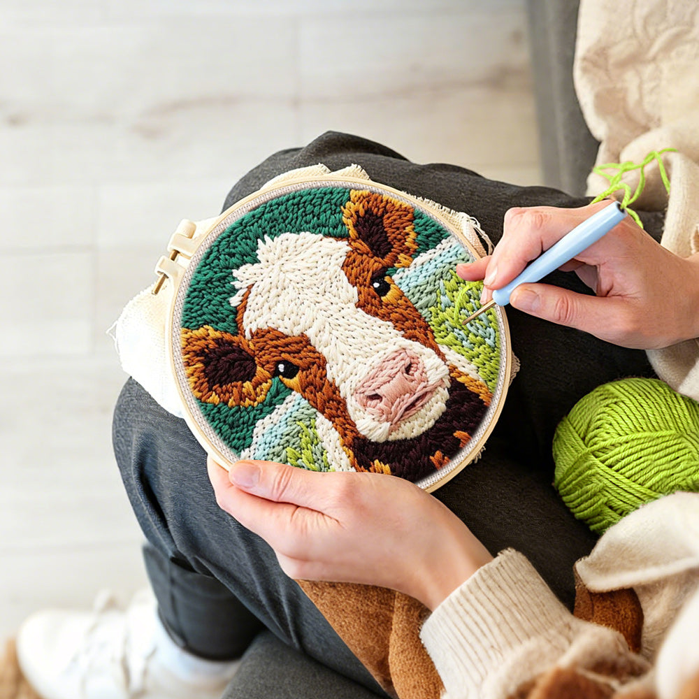 Creating handmade brown and white cow face punch needle artwork