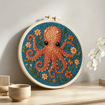 Brown octopus and flowers punch needle artwork displayed on a table