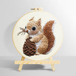 Brown squirrel holding pine cone punch needle kit for beginners