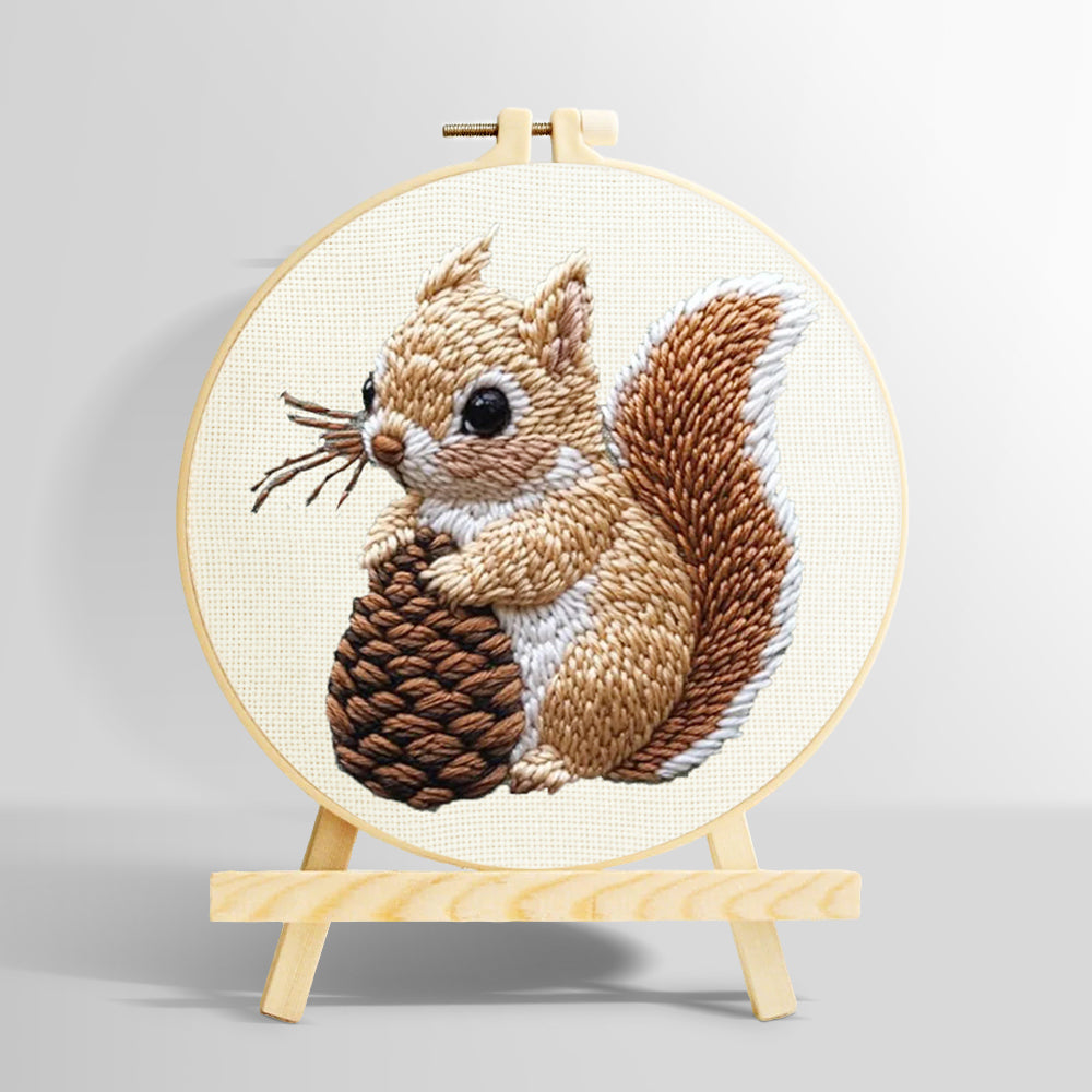 Brown squirrel holding pine cone punch needle kit for beginners