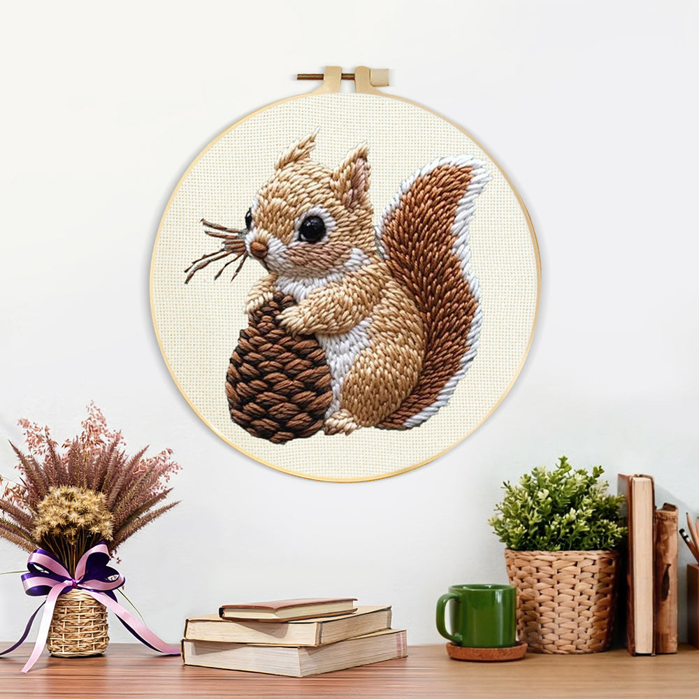 Finished brown squirrel holding pine cone artwork displayed on a wall