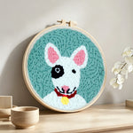 Bull terrier punch needle artwork displayed on a table