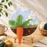 Finished bunny pulling a giant carrot needle felting displayed on a wooden easel