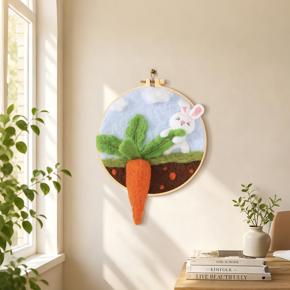 Bunny pulling a giant carrot needle felt wall art displayed in a bright home interior