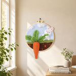 Bunny pulling a giant carrot needle felt wall art displayed in a bright home interior