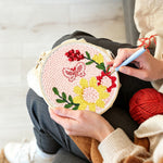Creating handmade butterfly and blooming flowers punch needle artwork