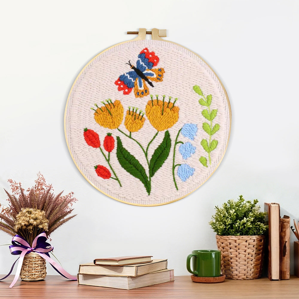 Finished butterfly and garden wildflowers artwork displayed on a wall
