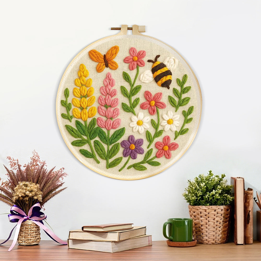 Finished butterfly, bee and wildflower artwork displayed on a wall