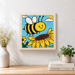 Finished buzzing bee with giant sunflower artwork displayed on a wall