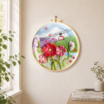 Cable car over mountain flowers needle felt wall art displayed in a bright home interior