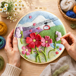 Creating the cable car over mountain flowers wool painting by hand with a felting needle