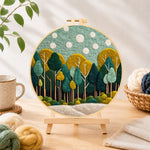 Finished calming green forest needle felting displayed on a wooden easel