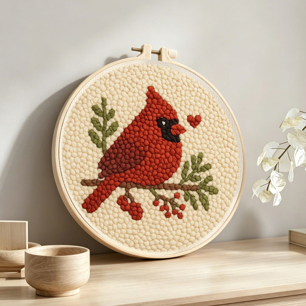 Cardinal and berries punch needle artwork displayed on a table