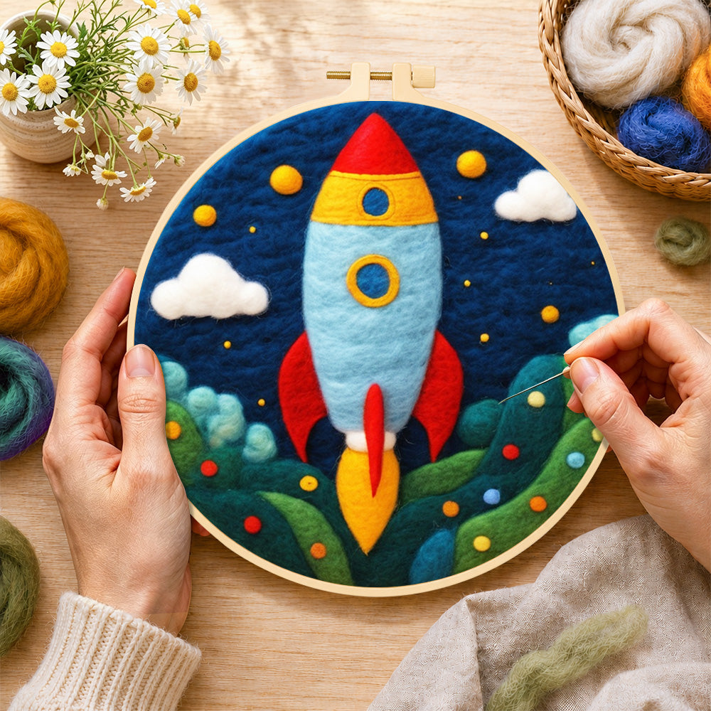 Creating the cartoon rocket launch wool painting by hand with a felting needle
