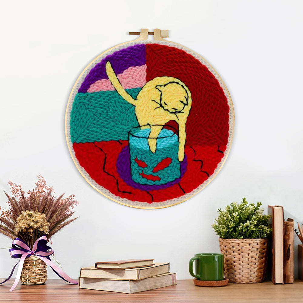 Finished cat and fish tank artwork displayed on a wall
