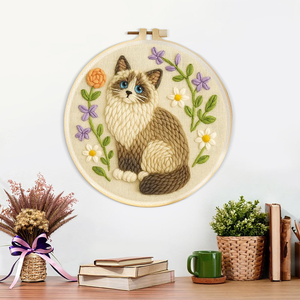Finished cat and wildflowers artwork displayed on a wall