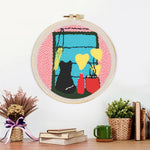 Finished cat silhouette by window with plants and vases artwork displayed on a wall