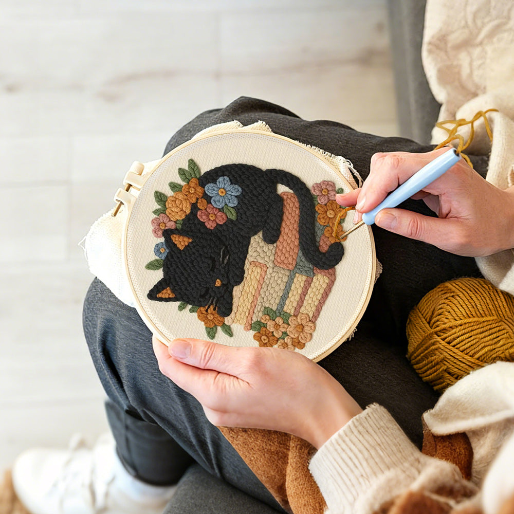 Creating handmade cat sleeping on books punch needle artwork
