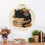 Finished cat sleeping on books artwork displayed on a wall
