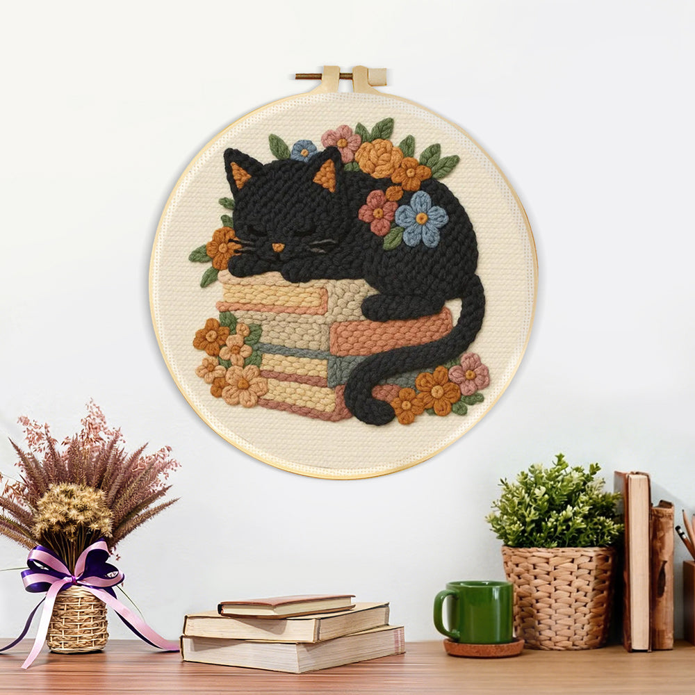 Finished cat sleeping on books artwork displayed on a wall