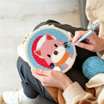 Creating handmade cat wearing a santa hat punch needle artwork