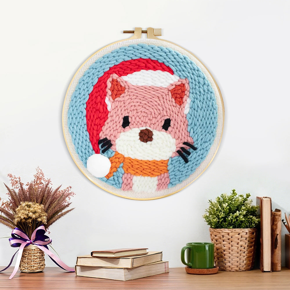 Finished cat wearing a santa hat artwork displayed on a wall
