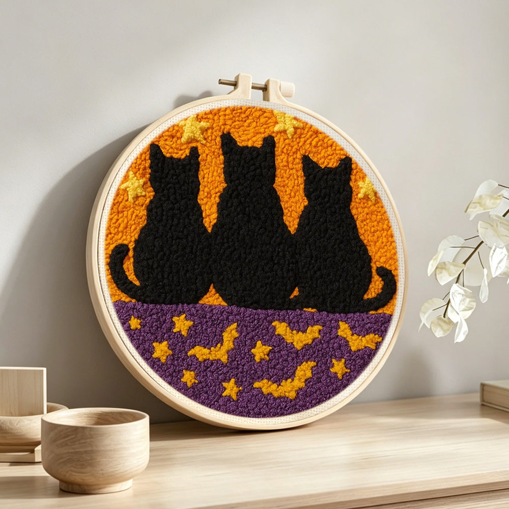 Cats and bats punch needle artwork displayed on a table