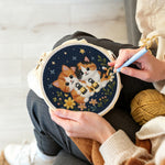 Creating handmade cats and wildflowers under the night sky punch needle artwork