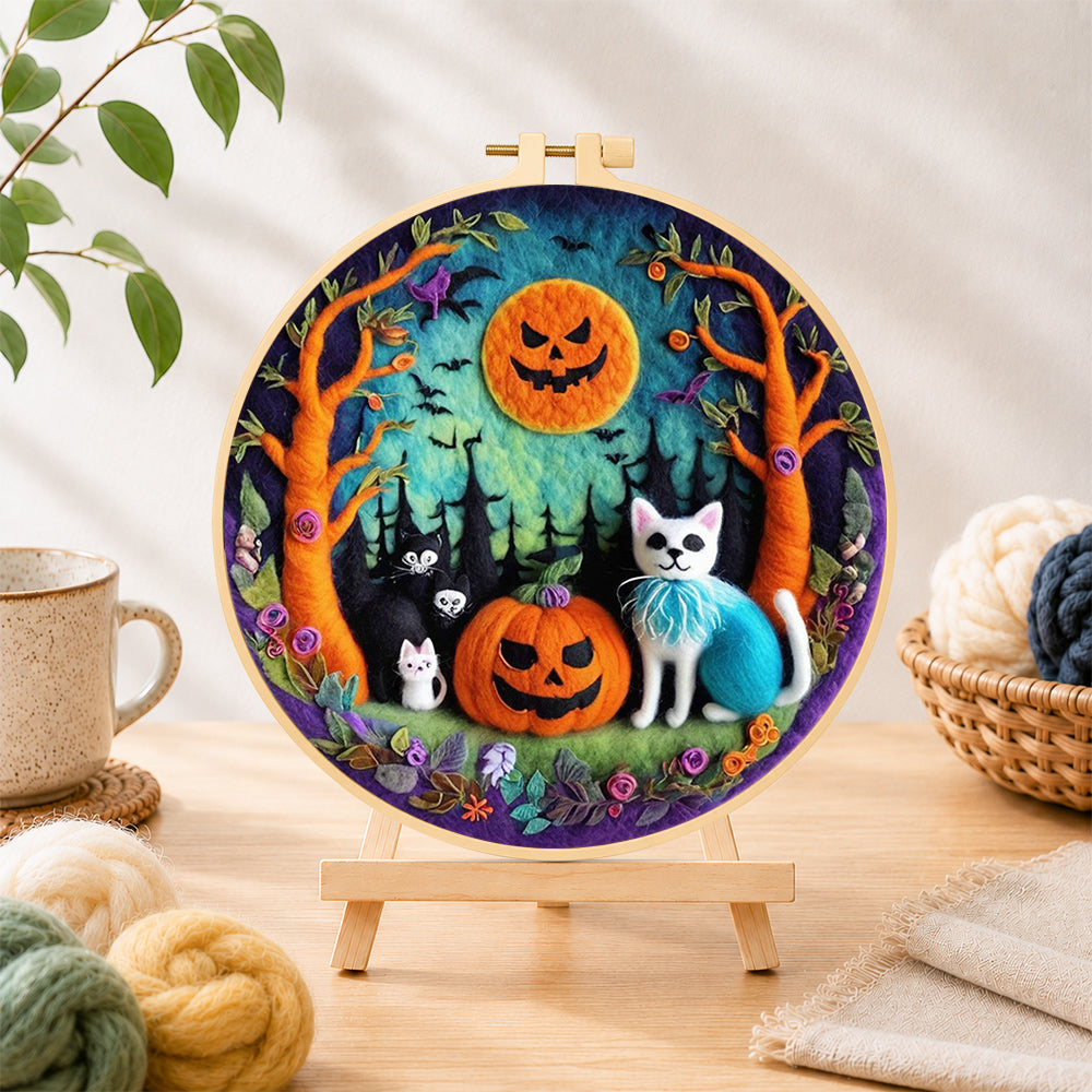 Finished cats in forest with pumpkins needle felting displayed on a wooden easel