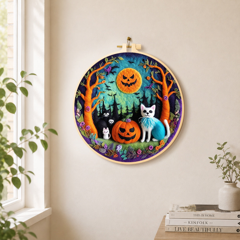 Cats in forest with pumpkins needle felt wall art displayed in a bright home interior