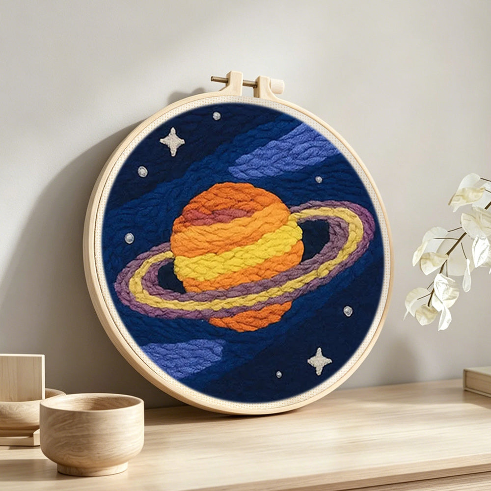 Celestial saturn punch needle artwork displayed on a table