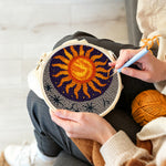 Creating handmade celestial sunburst and crescent moon punch needle artwork