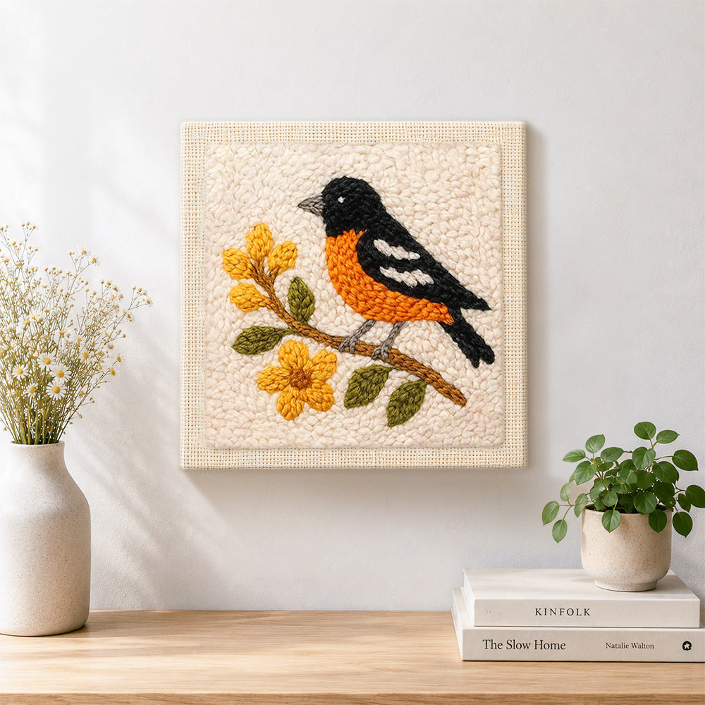 Finished charming bird on a flower branch artwork displayed on a wall