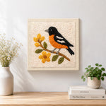 Finished charming bird on a flower branch artwork displayed on a wall