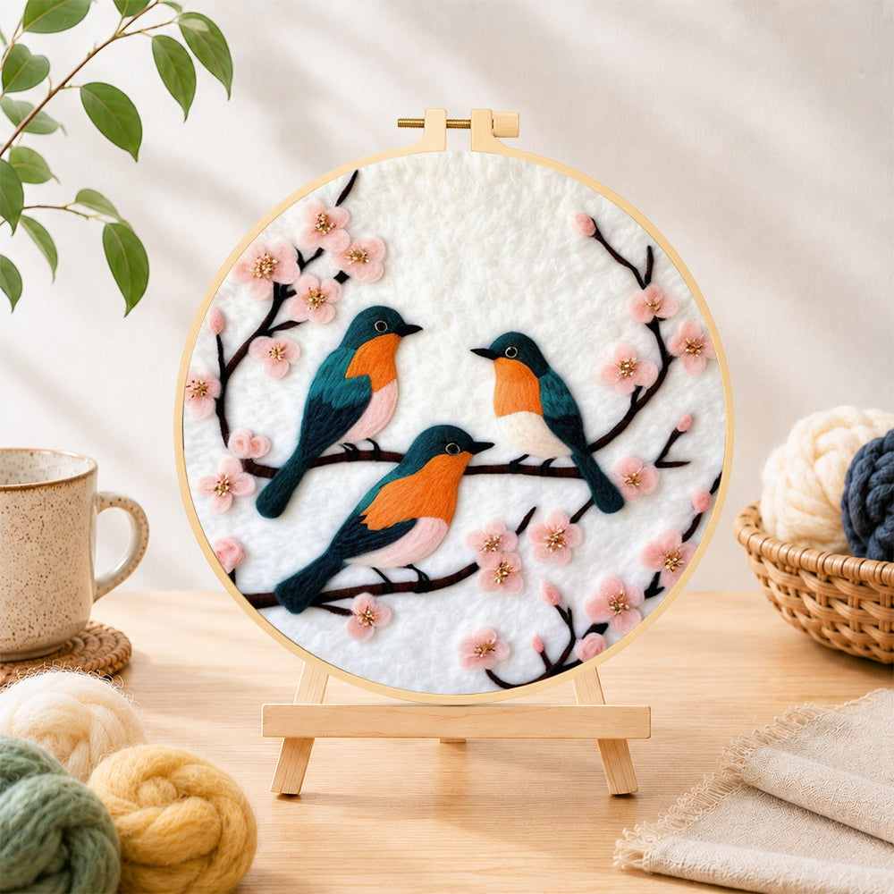 Finished charming birds on pink flower branch needle felting displayed on a wooden easel