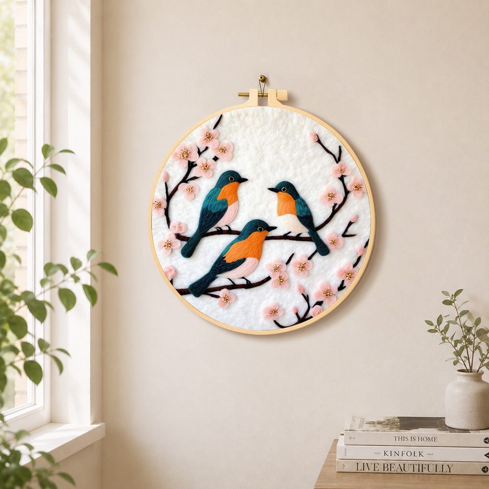 Charming birds on pink flower branch needle felt wall art displayed in a bright home interior