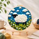 Finished charming black-faced sheep in sunny meadow needle felting displayed on a wooden easel