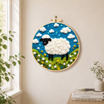 Charming black-faced sheep in sunny meadow needle felt wall art displayed in a bright home interior