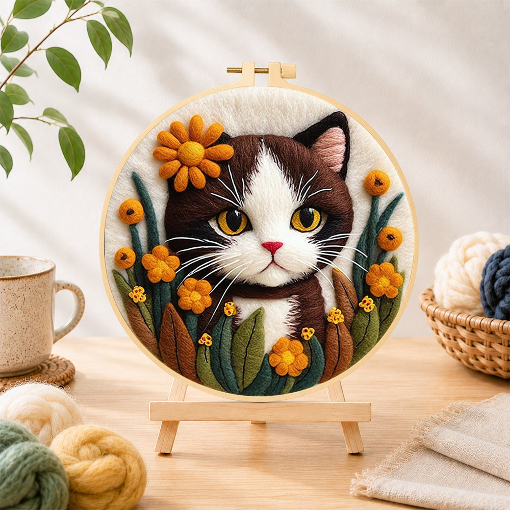 Finished charming brown and white cat with flowers needle felting displayed on a wooden easel